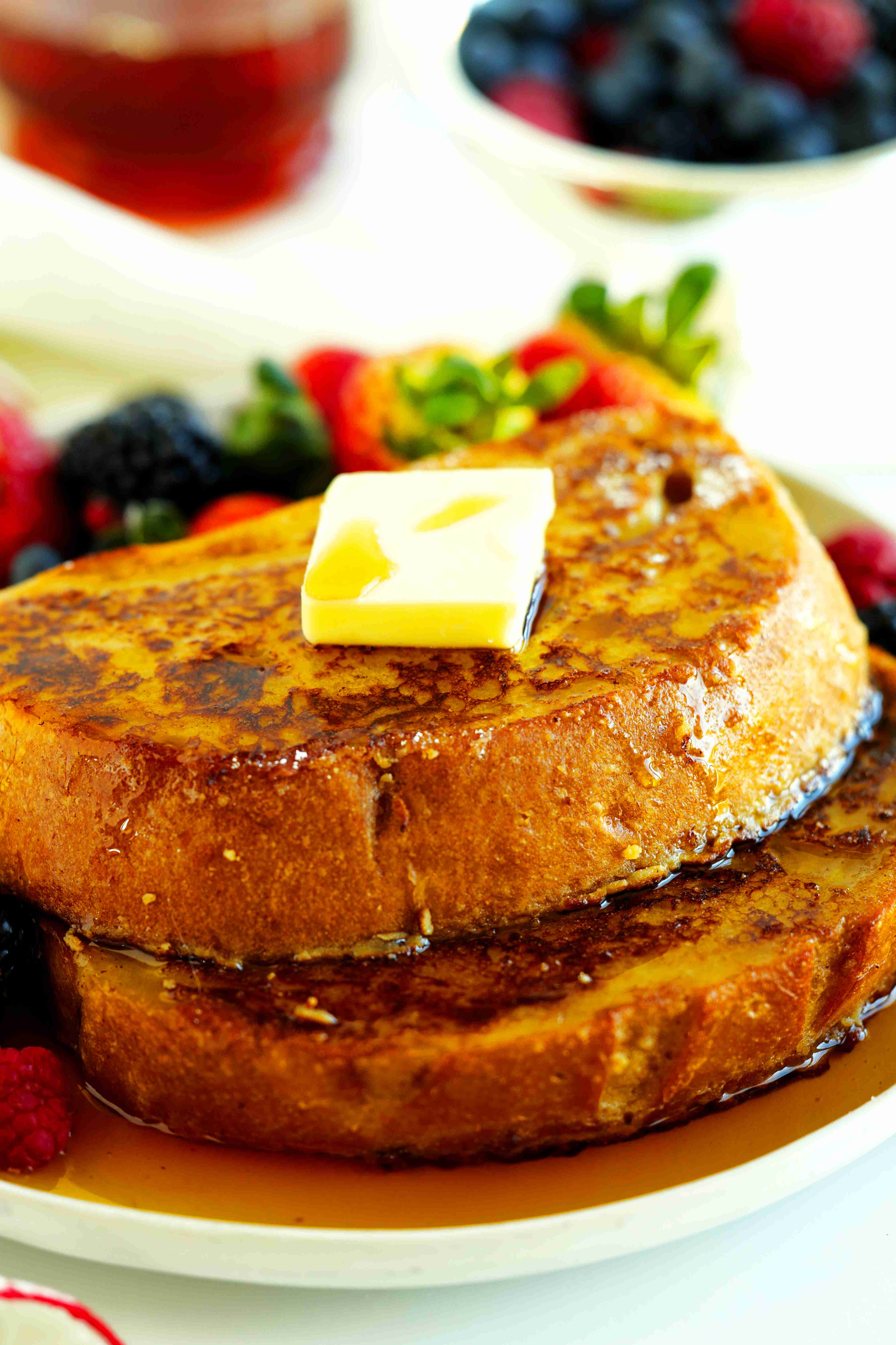 Sourdough French toast with fresh berries, maple syrup, and butter