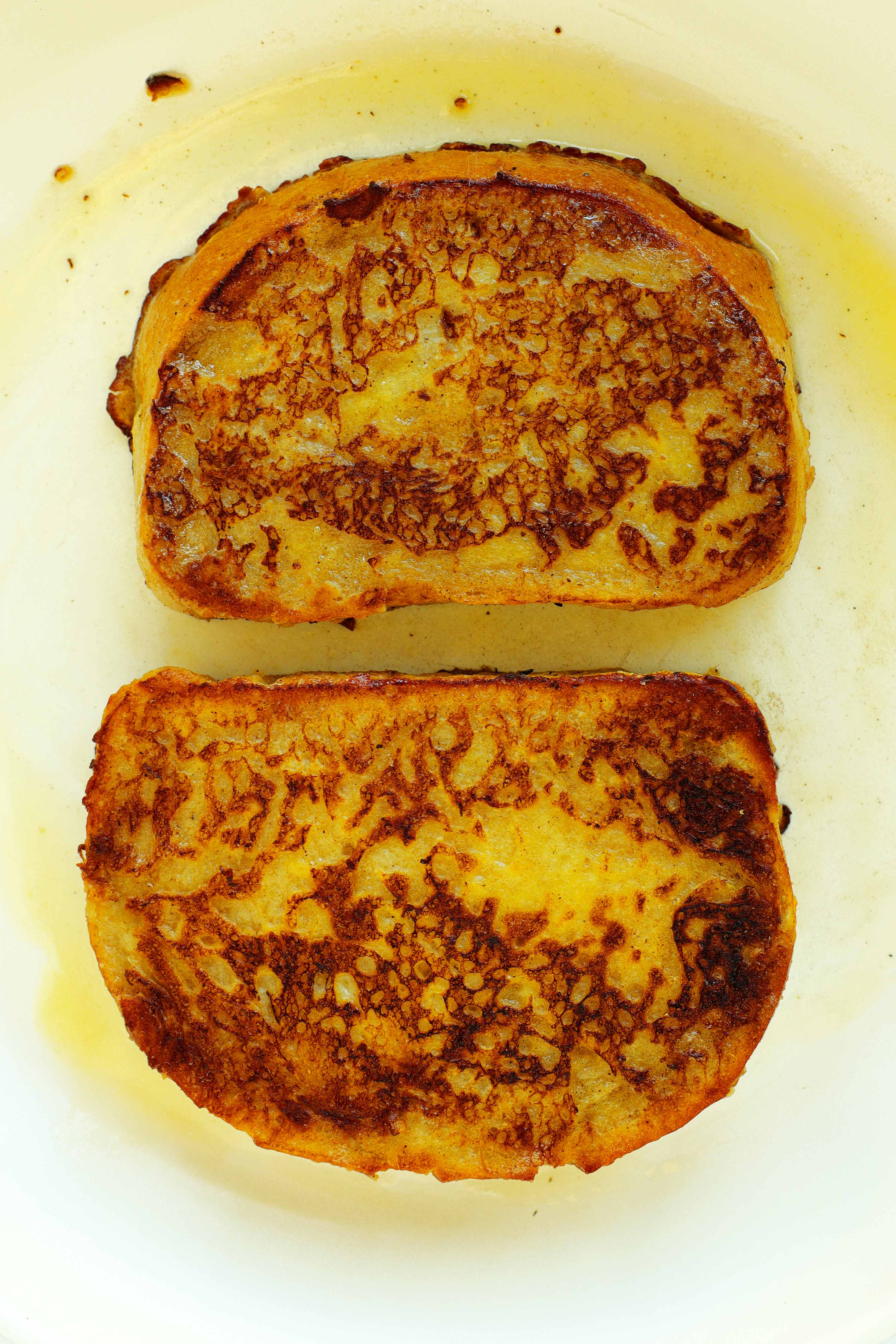 Overhead shot of cooked Sourdough French toast in a skillet