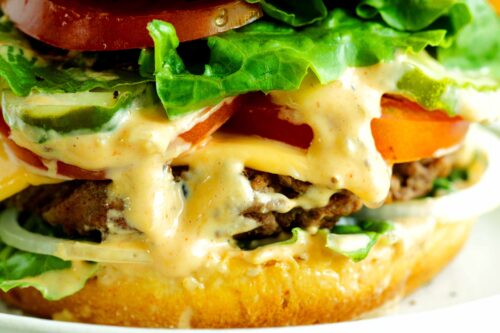 Close up of a homemade burger sauce on a loaded burger
