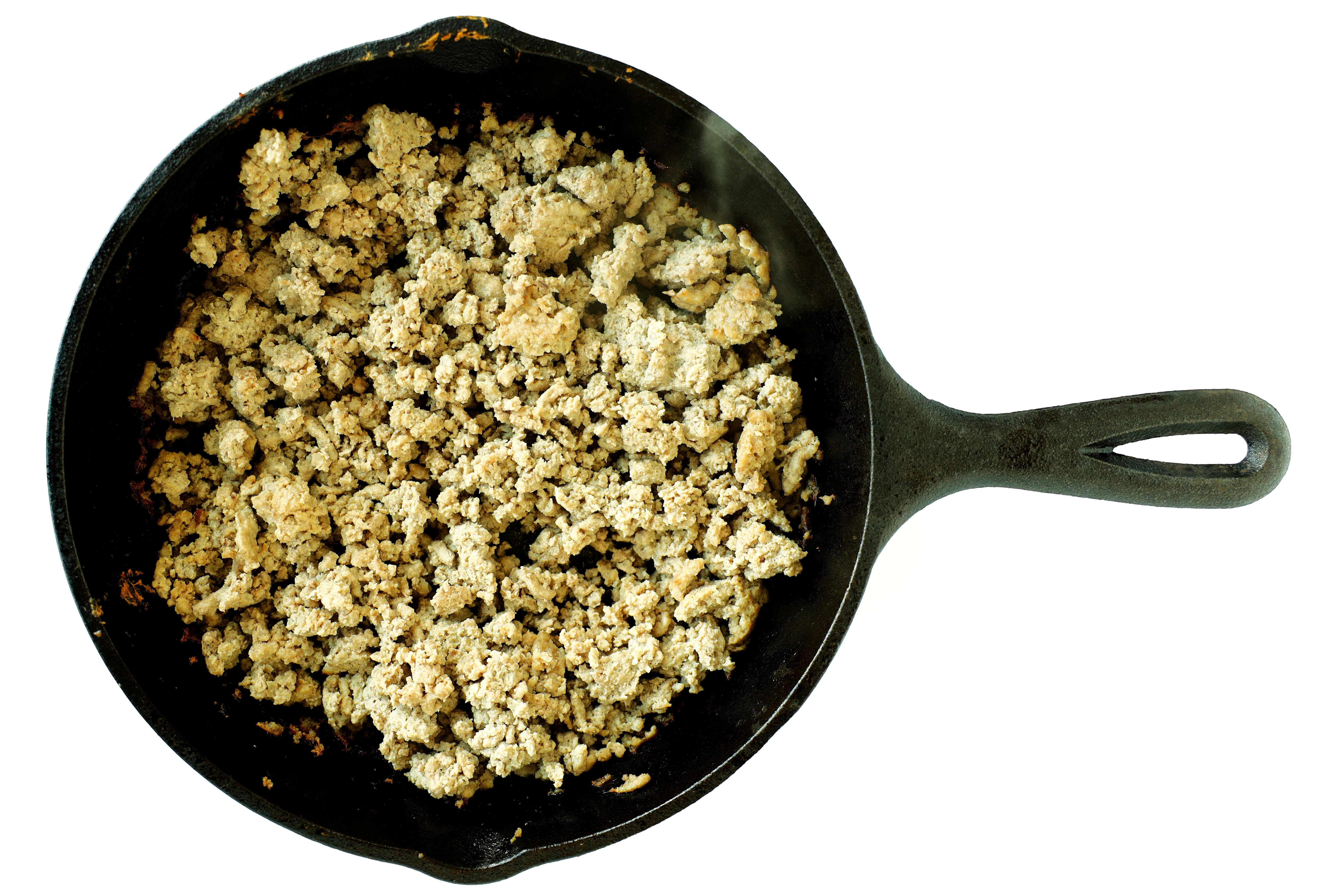 Ground turkey cooking in a cast iron skillet