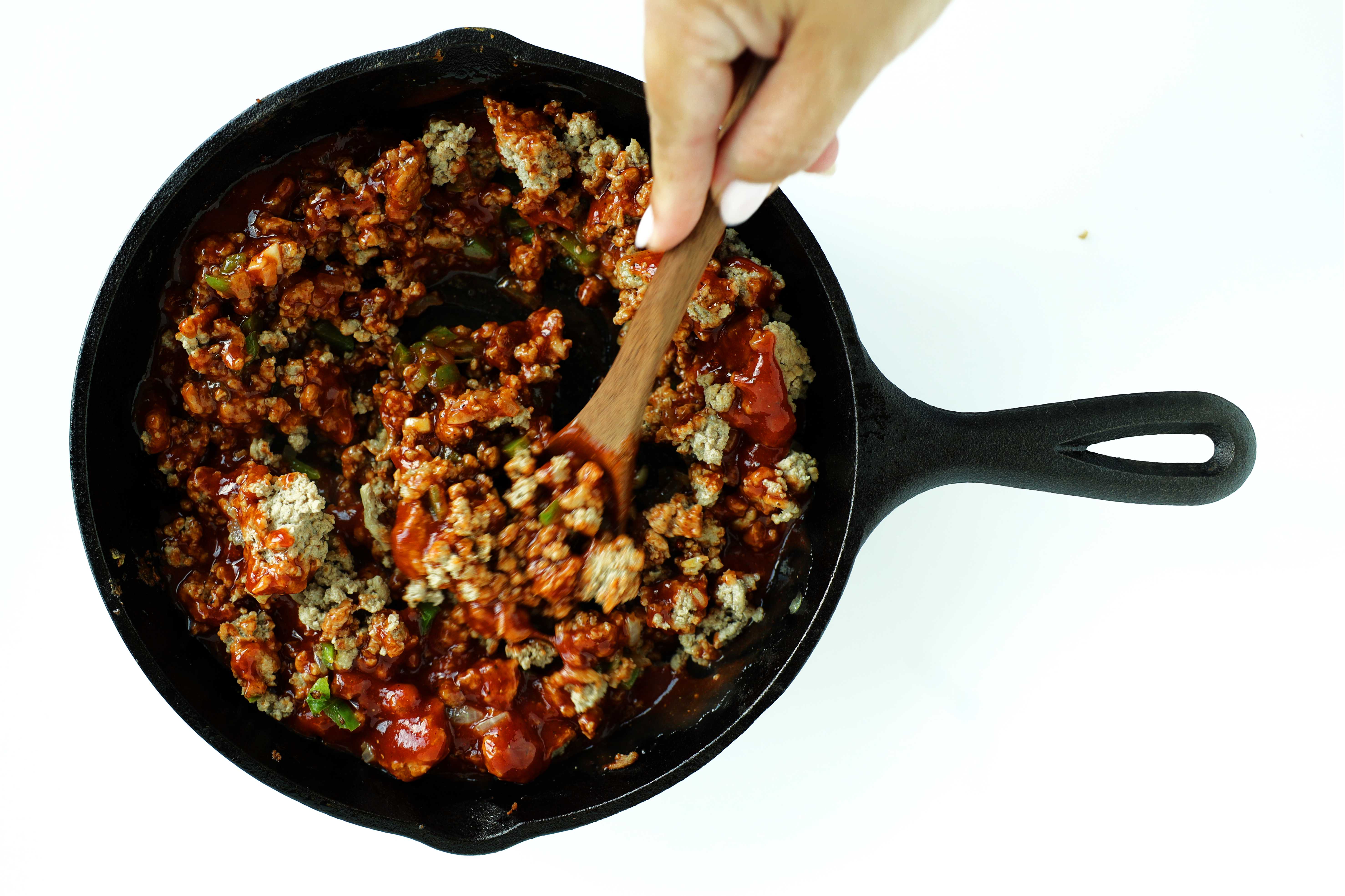 All ingredients for turkey sloppy joes in a cast iron skillet