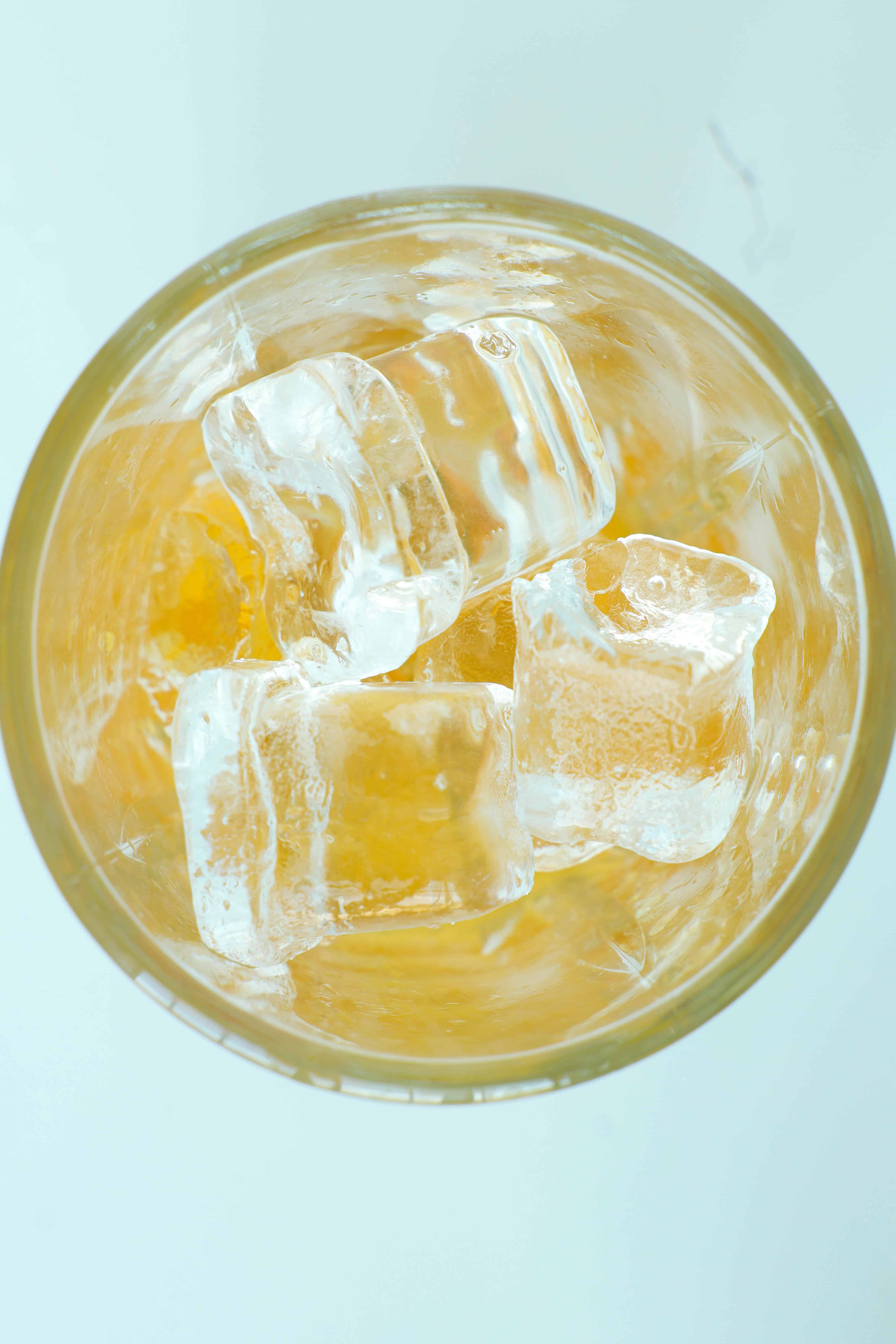 Peach Bourbon Smash in a rock glass with ice