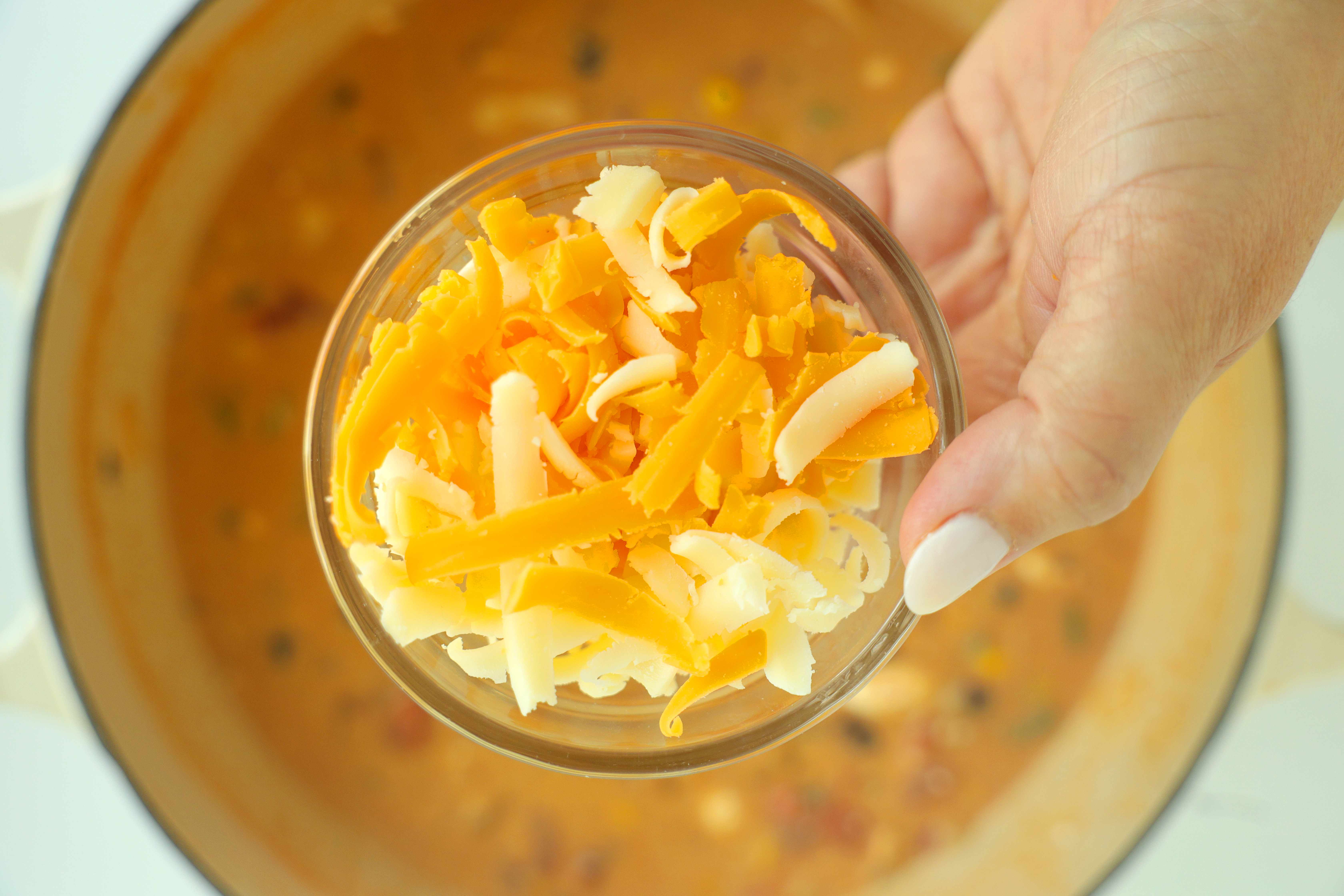 Overhead shot of grated Monterrey Jack and cheddar cheeses