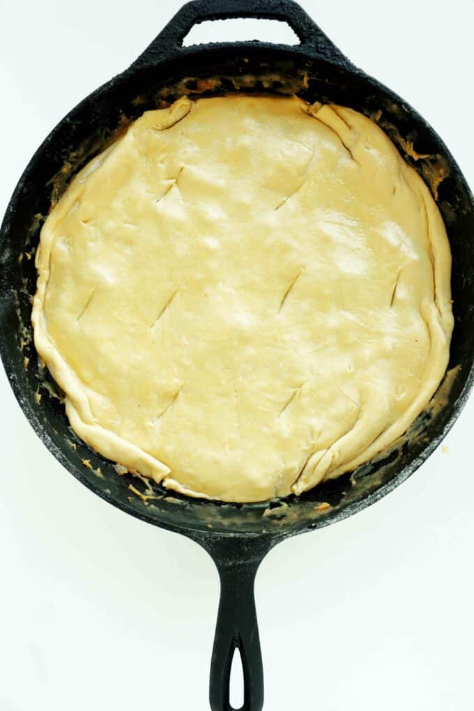 Overhead shot of uncooked Chicken Pot Pie with Puff Pastry in a cast iron skillet