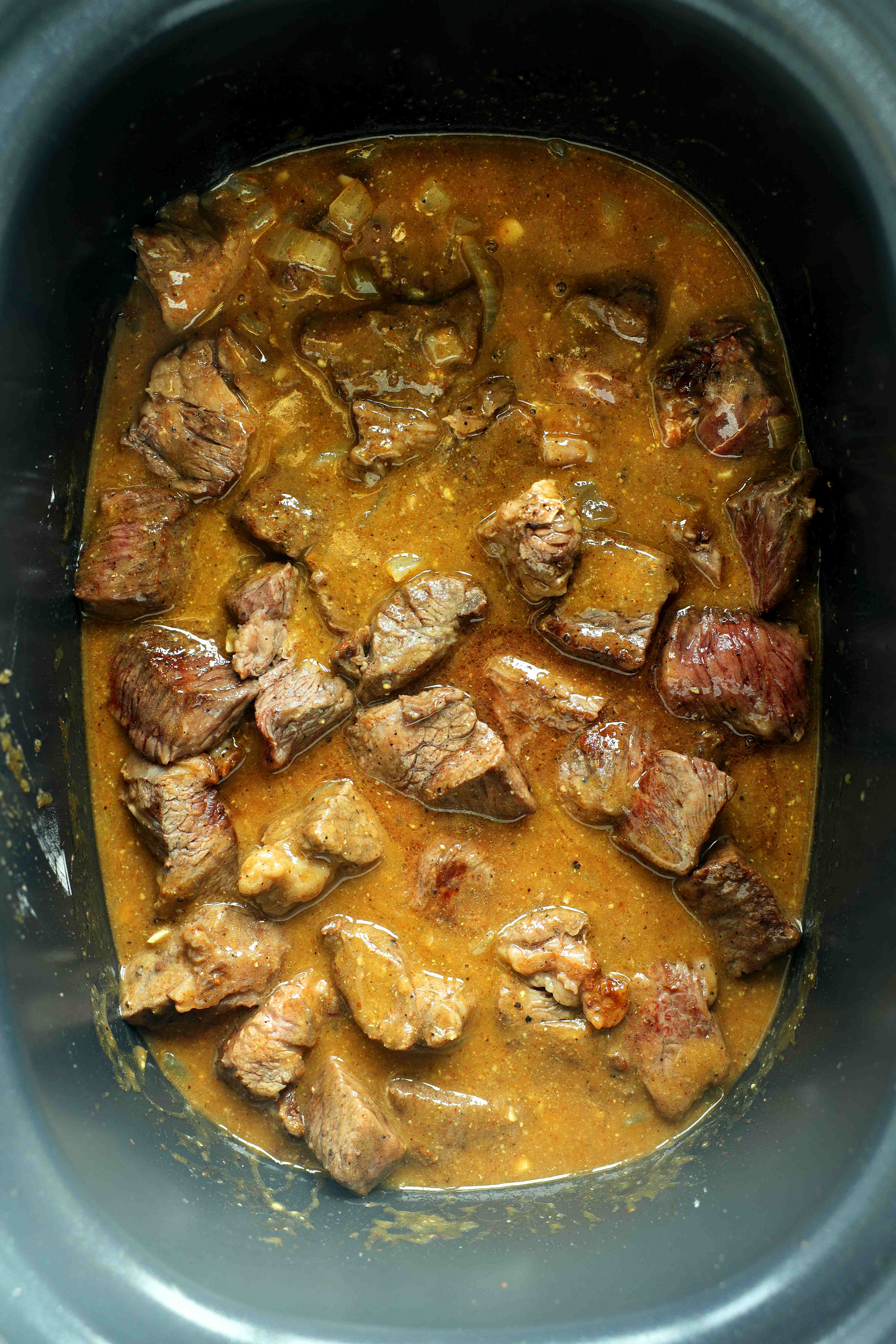 All ingredients except for mushrooms int he crockpot for beef tips and gravy