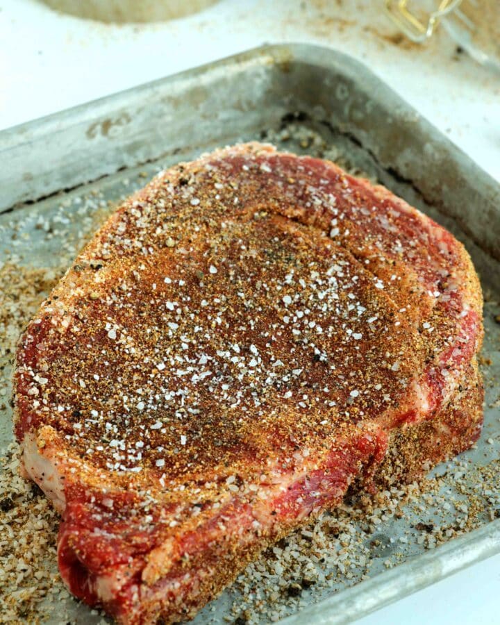 Homemade seasoning for steak on an uncooked cut of beef