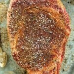 Steak Seasoning on an uncooked cut of beef