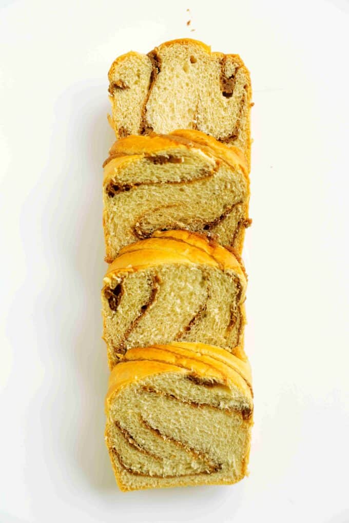 Brioche loaf sliced into thick pieces, showing a soft, enriched crumb.