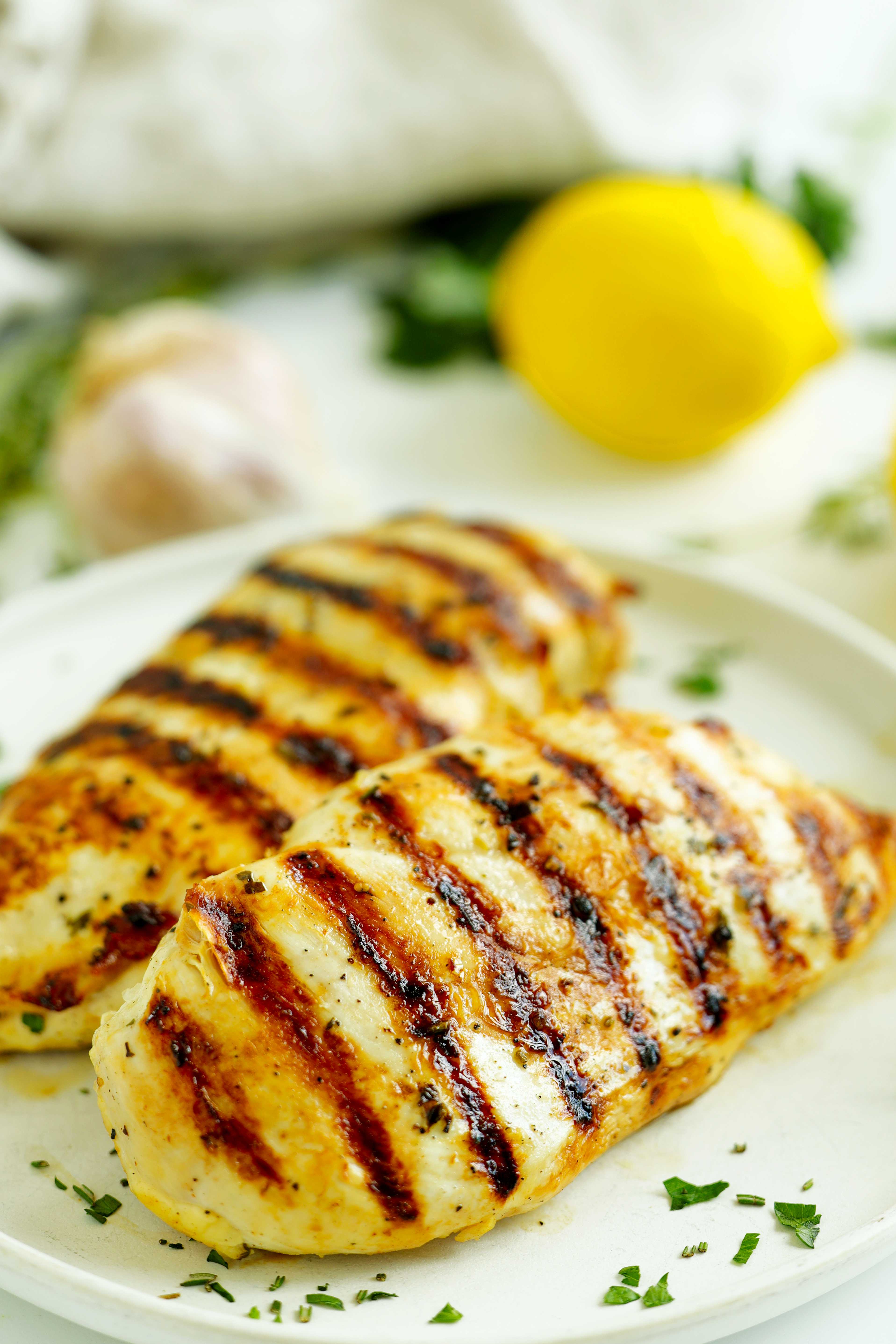 Grilled chicken breasts with golden grill marks, made with a lemon garlic marinade