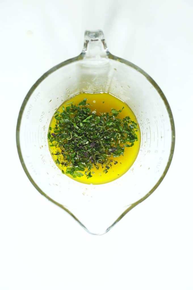 Fresh herbs mixed into olive oil and lemon juice for a homemade chicken marinade