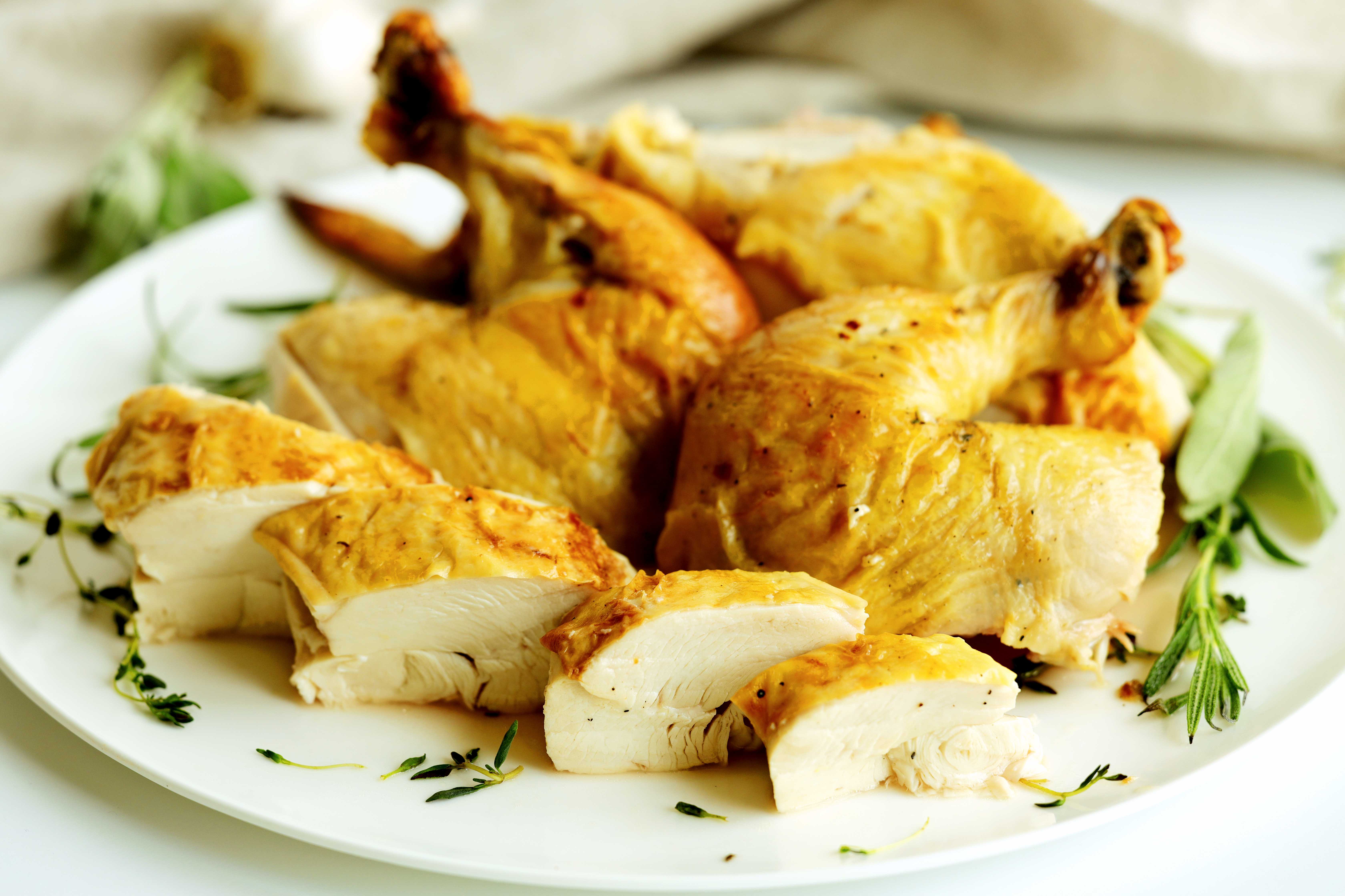 Sliced roasted chicken breast showing juicy, tender meat