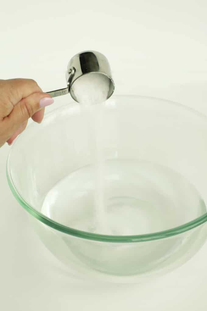Adding salt to bowl of water for chicken brine