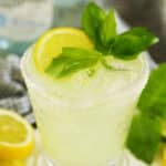 Close-up limoncello margarita with ice, lemon, basil, and a sugar rim