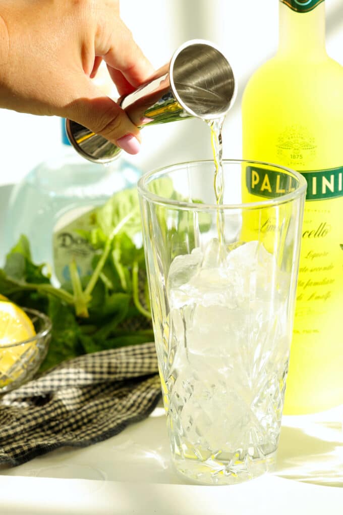 Measuring limoncello into a shaker filled with ice
