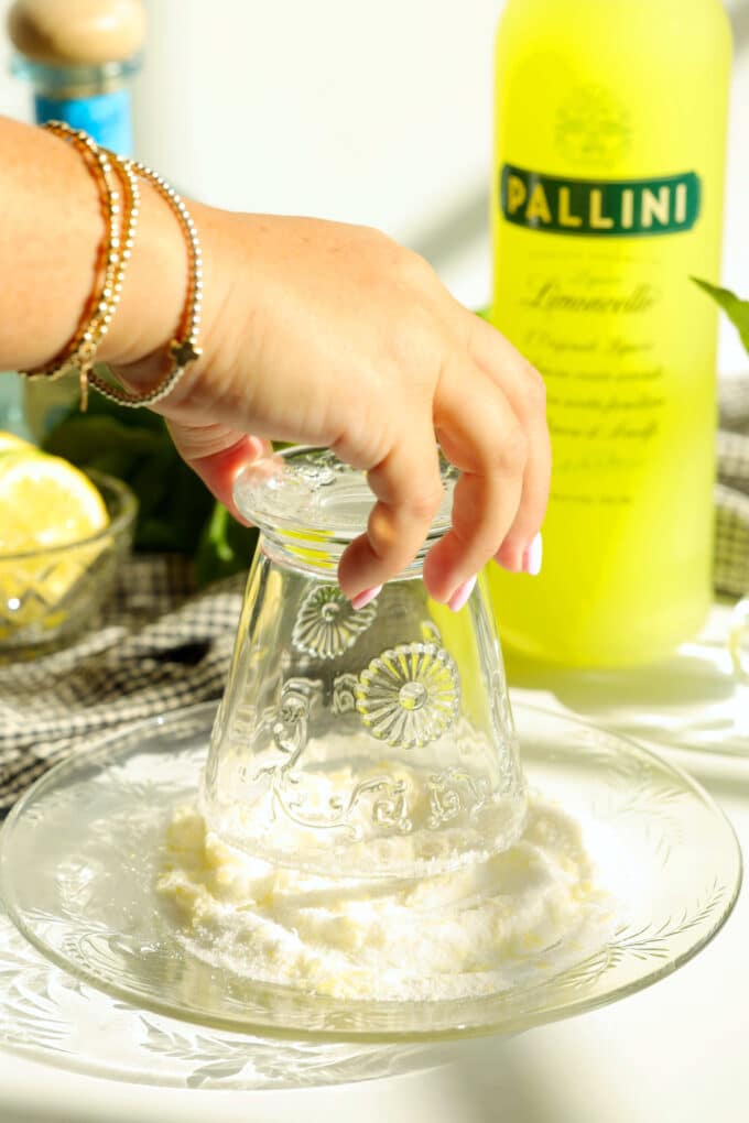 Rimming a glass with lemon sugar for limoncello margaritas