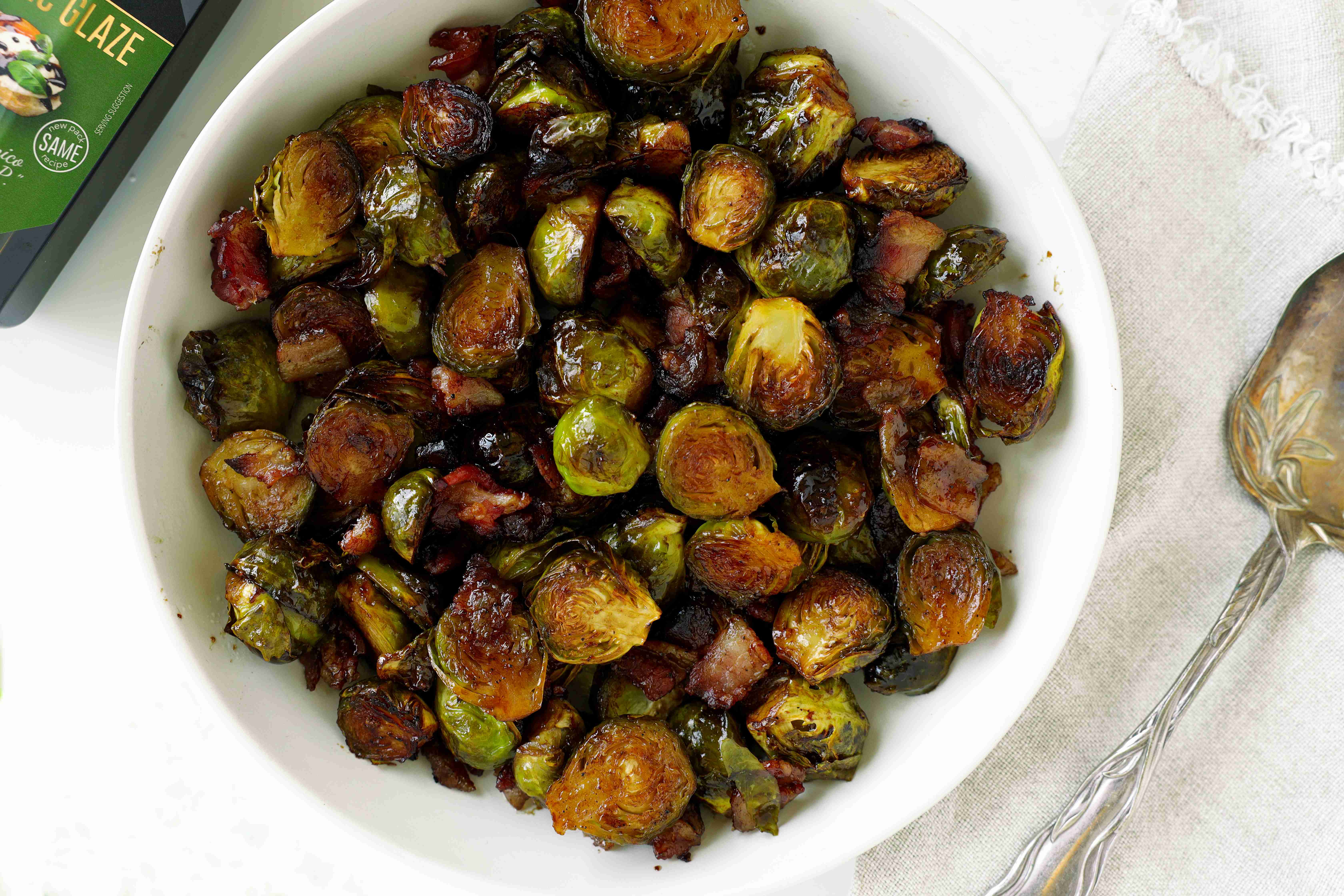 Crispy roasted Brussels sprouts with bacon and caramelized cut sides in a serving bowl