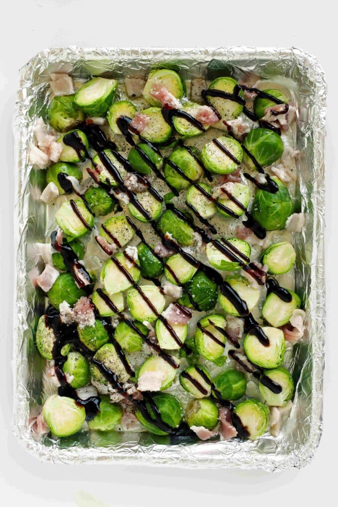 Balsamic glaze drizzled over Brussels sprouts and bacon before roasting