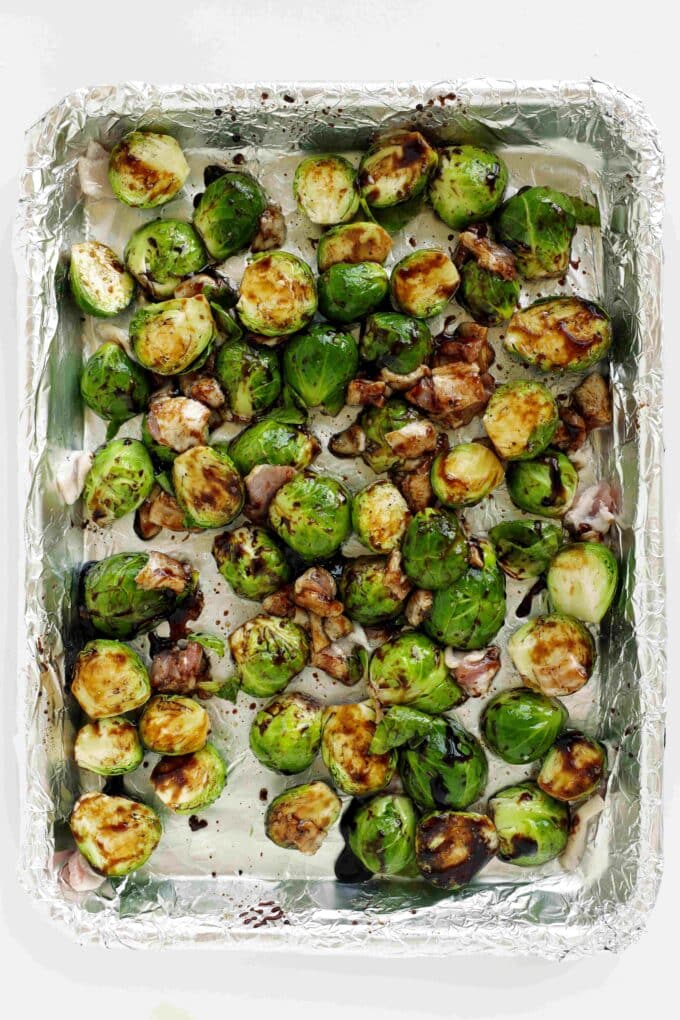 Brussels sprouts, bacon, oil, balsamic glaze, salt, and pepper tossed on a sheet pan